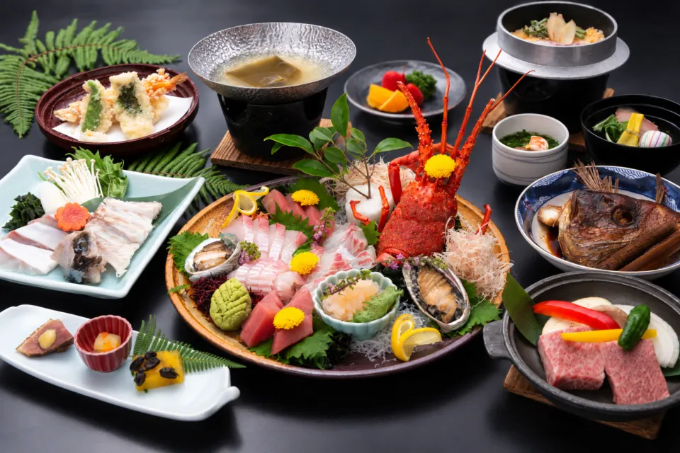 加太海月の伊勢海老やあわび、肉料理を並べた会席料理