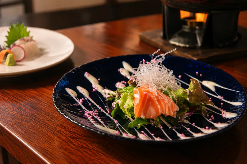 座・寿鈴の青い器に盛られたサーモンの料理