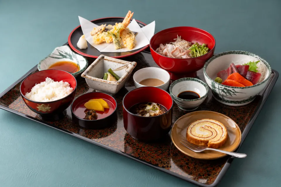 芭蕉館の刺身と天ぷら、ケーキを添えた団体向けの膳