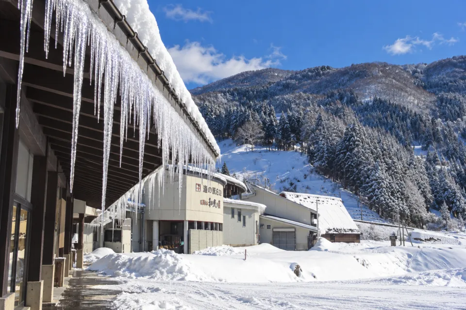 五箇山の味 ふるさとの軒下のつららと雪山の景色