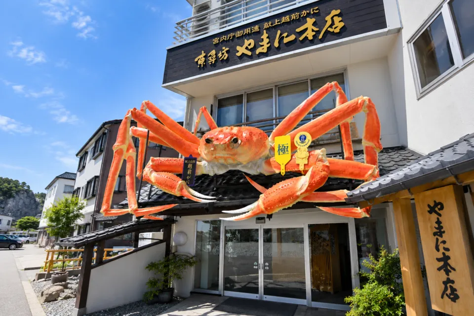 やまに水産の大きなカニのオブジェがある本館外観
